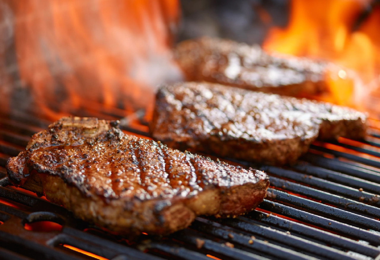 Grilled steaks on a hot grill.