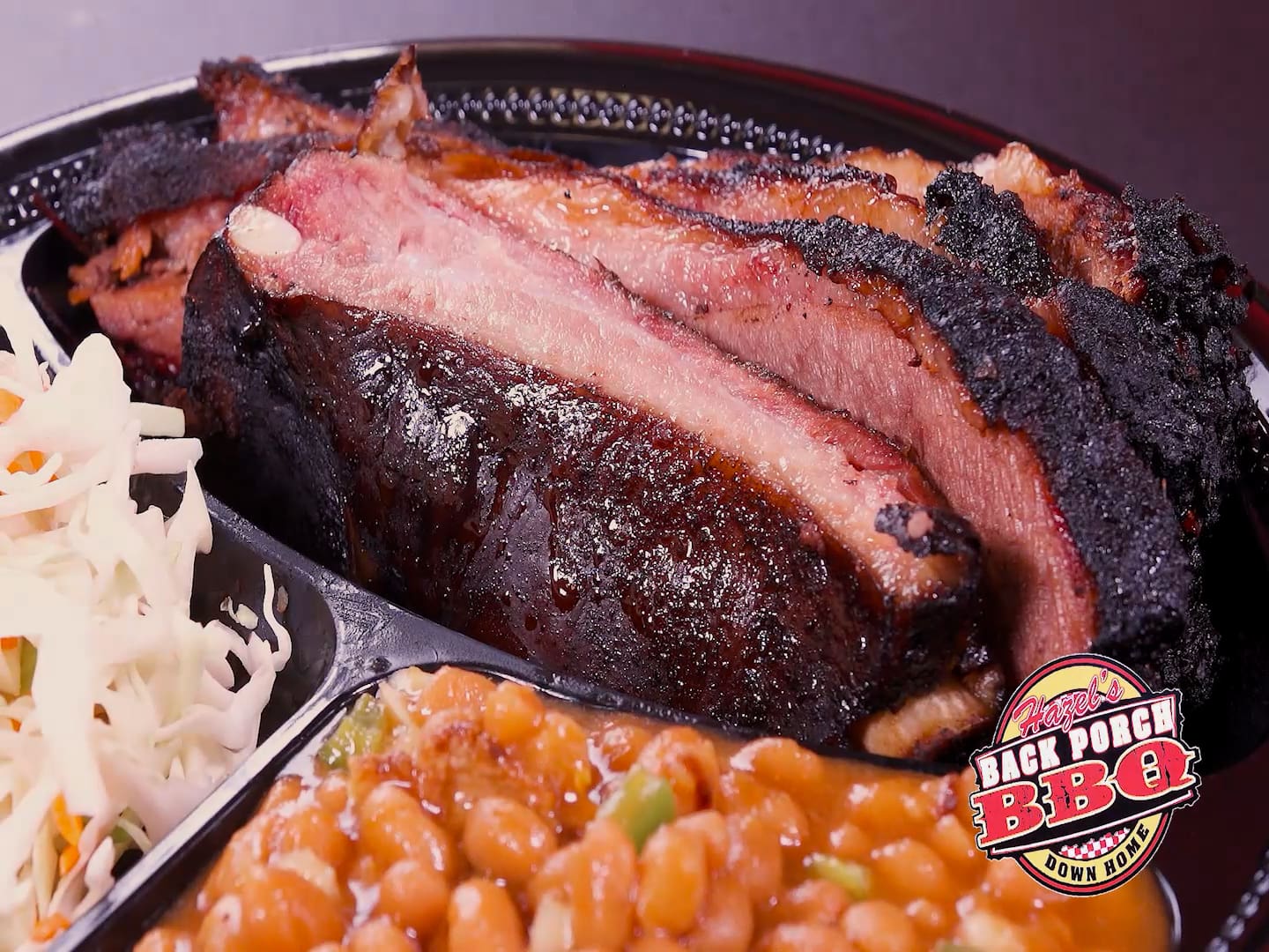 A close up of a plate with meat and beans